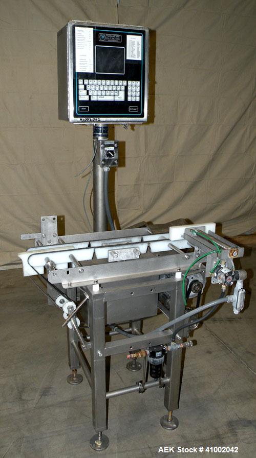 Used Whitney Packaging/Processing Corp Datachek Checkweigher, Model DC-300M. Capable of speeds up to 300 CPM and weights up to 3Kg or 6.6 lbs. Accuracies of +/- 1 gram or .5%. Left to right operation...