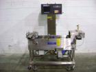Used Hi-Speed Mettler Toledo Checkweigher, Model CM6400WD-CM. Stainless steel. Side belt driven infeed, and discharge. Approximate 36’’ chain weigh section, weight range up to 20 pounds. Capable of s...