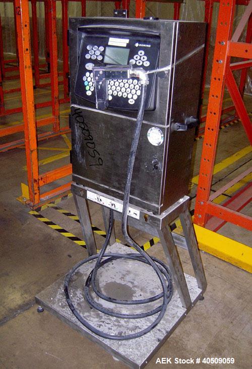 Used Domino Ink Jet Coder, Model A300. Mounted on a cart with casters.