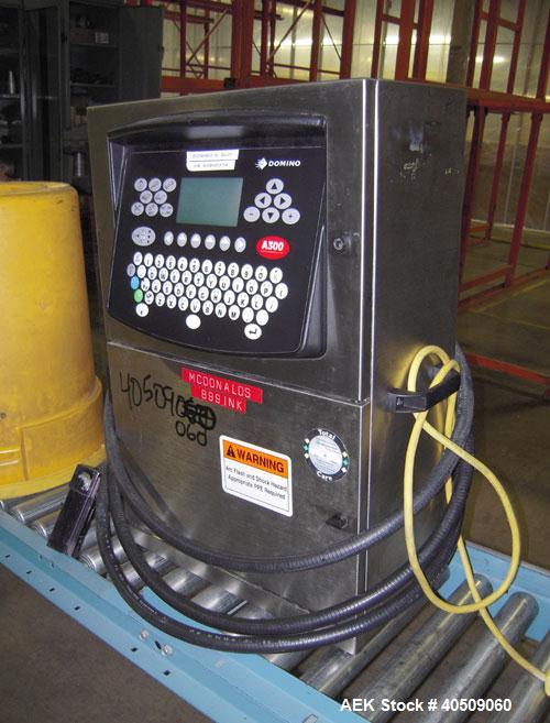 Used Domino Ink Jet Coder, Model A300. Mounted on a cart with casters.