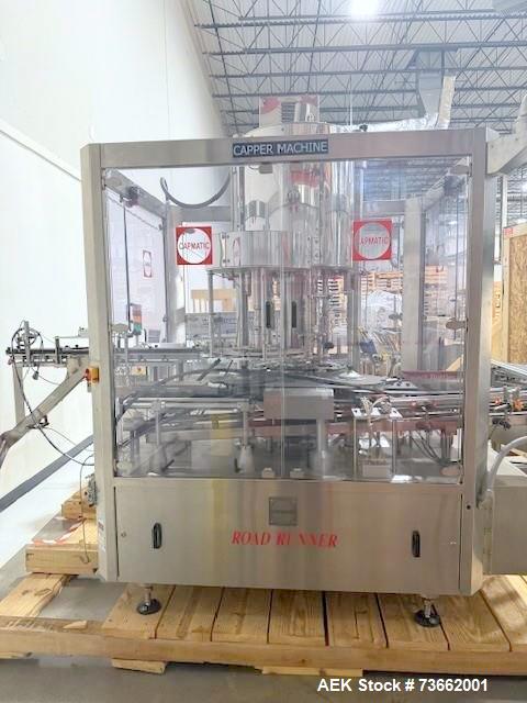 Used Capmatic Bottling Line, Model Verifill. Line consists of: (1) Capmatic Bottle Cleaner, (1) Capmatic rotary chuck capper, model Roadrunner 4HM, (1) LSI pressure sensitive wraparound labeler, mode...