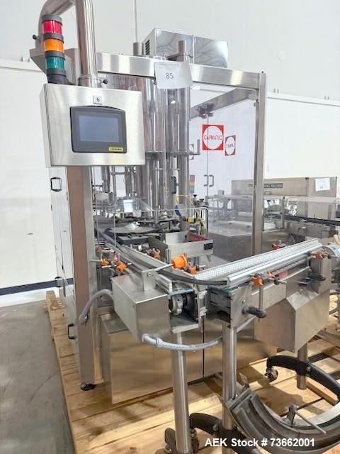 Used Capmatic Bottling Line, Model Verifill. Line consists of: (1) Capmatic Bottle Cleaner, (1) Capmatic rotary chuck capper, model Roadrunner 4HM, (1) LSI pressure sensitive wraparound labeler, mode...