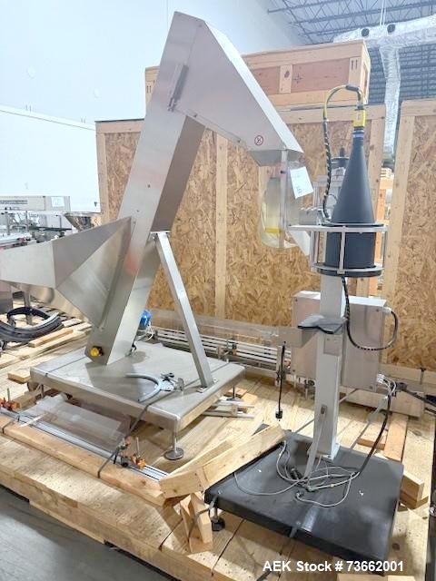 Used Capmatic Bottling Line, Model Verifill. Line consists of: (1) Capmatic Bottle Cleaner, (1) Capmatic rotary chuck capper, model Roadrunner 4HM, (1) LSI pressure sensitive wraparound labeler, mode...