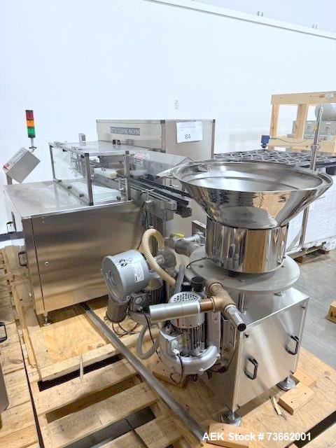 Used Capmatic Bottling Line, Model Verifill. Line consists of: (1) Capmatic Bottle Cleaner, (1) Capmatic rotary chuck capper, model Roadrunner 4HM, (1) LSI pressure sensitive wraparound labeler, mode...
