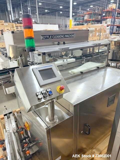 Used Capmatic Bottling Line, Model Verifill. Line consists of: (1) Capmatic Bottle Cleaner, (1) Capmatic rotary chuck capper, model Roadrunner 4HM, (1) LSI pressure sensitive wraparound labeler, mode...