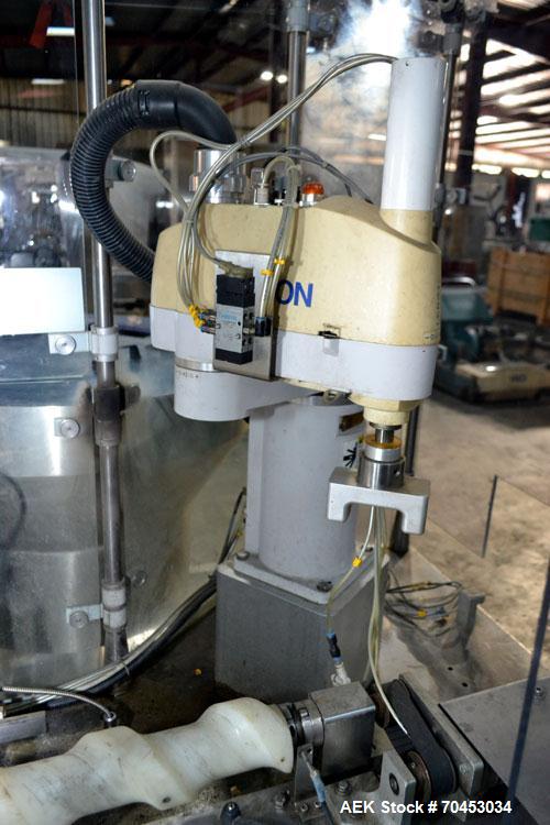 Used Capmatic Straight Line Automatic “Puck Style” Fragrance Line, Model Patriot L, S/N PA03101111, new 2004.  3/60/480V/20A.  6 Head Straight Line Vacuum Filler, Model Vacufill, S/N RV03101110, with...