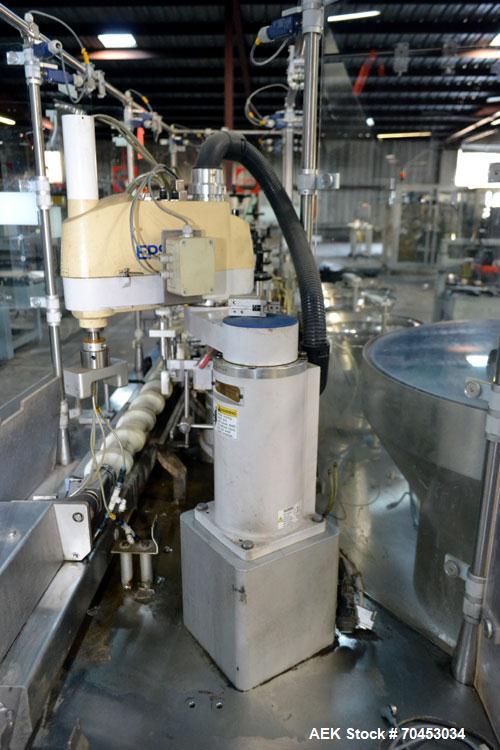Used Capmatic Straight Line Automatic “Puck Style” Fragrance Line, Model Patriot L, S/N PA03101111, new 2004.  3/60/480V/20A.  6 Head Straight Line Vacuum Filler, Model Vacufill, S/N RV03101110, with...