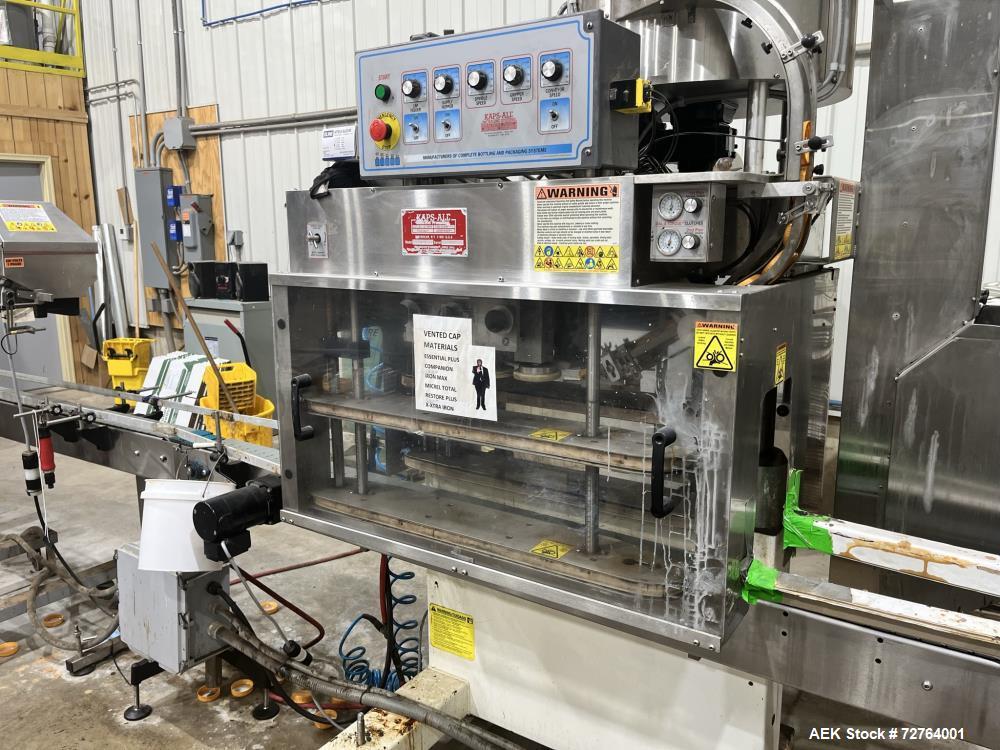 Used Inline Filling Systems Complete Liquid Filling Line. Line Consists of 10 Head Inline Fillers, Kapsall Model A6-R Capper with Integrated Cap Elevator and Centrifugal Cap Sorter, Dual Belt, Kapsal...