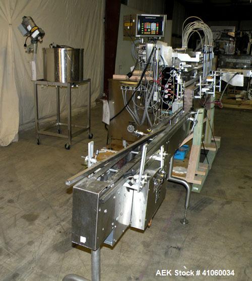 Used Kalish Liquid Bottle Filling Lineconsisting of: (1) Kalishtronic 8 head inline bottom up filler, Model KT12. (8) 5/8’’ diameter x 8-7/8’’ long diving nozzles, set up for approximately 946 ml. (8...