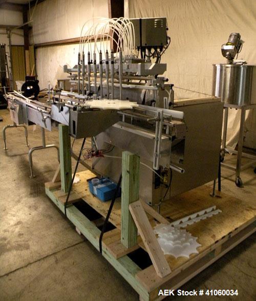 Used Kalish Liquid Bottle Filling Lineconsisting of: (1) Kalishtronic 8 head inline bottom up filler, Model KT12. (8) 5/8’’ diameter x 8-7/8’’ long diving nozzles, set up for approximately 946 ml. (8...