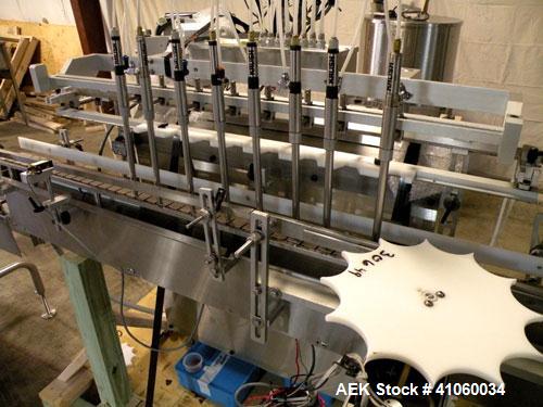 Used Kalish Liquid Bottle Filling Lineconsisting of: (1) Kalishtronic 8 head inline bottom up filler, Model KT12. (8) 5/8’’ diameter x 8-7/8’’ long diving nozzles, set up for approximately 946 ml. (8...