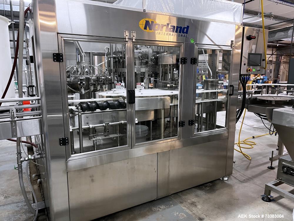 Used Complete Filling line for Bottle, manufactured by Norland. Running 25oz Bottles