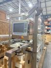 Used Capmatic Bottling Line, Model Verifill. Line consists of: (1) Capmatic Bottle Cleaner, (1) Capmatic rotary chuck capper, model Roadrunner 4HM, (1) LSI pressure sensitive wraparound labeler, mode...