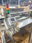 Used Capmatic Bottling Line, Model Verifill. Line consists of: (1) Capmatic Bottle Cleaner, (1) Capmatic rotary chuck capper, model Roadrunner 4HM, (1) LSI pressure sensitive wraparound labeler, mode...