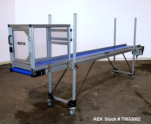 Used HFA Harvard Factory Automation Belt Conveyor.  18" Wide x 156" long belt. Driven by a 1/6 hp, 1/60/115 volt gear motor, ratio 106 to 1, output 82 rpm. Mounted on a manually adjustable height alu...