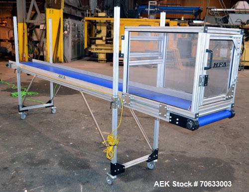Used HFA Harvard Factory Automation Belt Conveyor.  18" Wide x 156" long belt. Driven by a 1/6 hp, 1/60/115 volt gear motor, ratio 106 to 1, output 82 rpm. Mounted on a manually adjustable height alu...