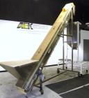 Used Kamflex Inclined Belt Conveyor, Model 705. 12’’ Wide x approximately 180’’ long rubber cleated belt. 6’’ Long pockets with 3’’ tall cleats. End feed hopper. Driven by an approximate 1/2 hp, 1/60...