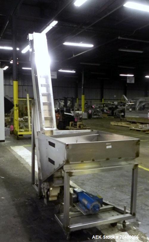 Used Hoppmann Cap Elevator, Stainless Steel. 5” wide x 102” long rubber belt, approximate 108” discharge height. Hopper approximate 46” x 38” x 28” deep. Hinged plexiglass top cover. Driven by a 1/4h...