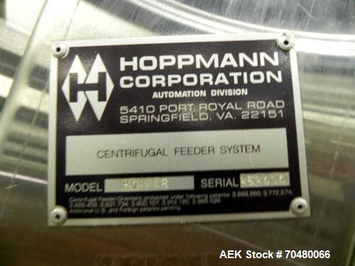 Used Hoppmann Cap Elevator, Stainless Steel. 5” wide x 102” long rubber belt, approximate 108” discharge height. Hopper approximate 46” x 38” x 28” deep. Hinged plexiglass top cover. Driven by a 1/4h...