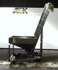 Used Hoppmann Cap Elevator, Stainless Steel. 5” wide x 102” long rubber belt, approximate 108” discharge height. Hopper approximate 46” x 38” x 28” deep. Hinged plexiglass top cover. Driven by a 1/4h...