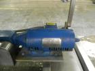 Used Hoppmann Cap Elevator, Stainless Steel. 5” wide x 102” long rubber belt, approximate 108” discharge height. Hopper approximate 46” x 38” x 28” deep. Hinged plexiglass top cover. Driven by a 1/4h...