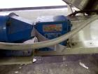 Used Hoppmann Cap Elevator, Stainless Steel. 5” wide x 102” long rubber belt, approximate 108” discharge height. Hopper approximate 46” x 38” x 28” deep. Hinged plexiglass top cover. Driven by a 1/4h...