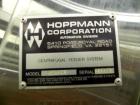 Used Hoppmann Cap Elevator, Stainless Steel. 5” wide x 102” long rubber belt, approximate 108” discharge height. Hopper approximate 46” x 38” x 28” deep. Hinged plexiglass top cover. Driven by a 1/4h...