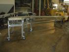 Used- Dead Case Roller Conveyor. 90 degree turn. All stainless steel frame mounted on casters.