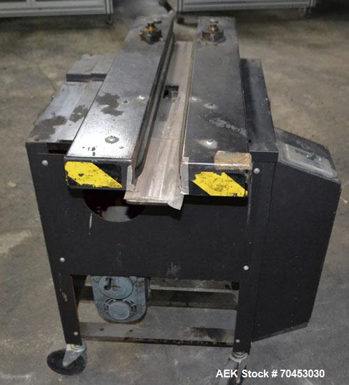 Used Dennison M400 Side Belt Gap Transfer Conveyor. Capable of speeds up to 250 CPM.  Side belt transfer for bottom coding of containers. Container size range: (length) 1" - 7" (width) 1" - 7" (heigh...