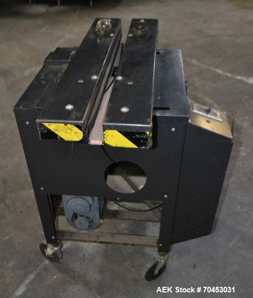Used Dennison M400 Side Belt Gap Transfer Conveyor. Capable of speeds up to 250 CPM.  Side belt transfer for bottom coding of containers. Container size range: (length) 1" - 7" (width) 1" - 7" (heigh...