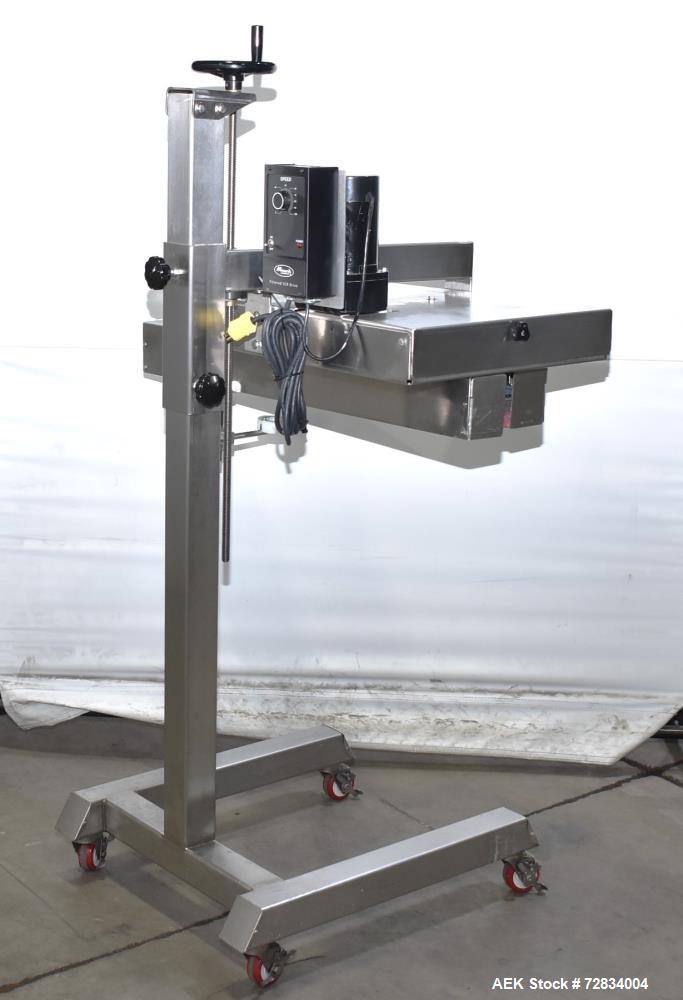 Used Garvey Side Belt Gap Transfer Conveyor. (2) Belts, approximate 39" long x 2" wide. Adjustable height. Mounted on casters. Last used with Video Jet coder for bottom date coding. 1/60/115 Volt.
