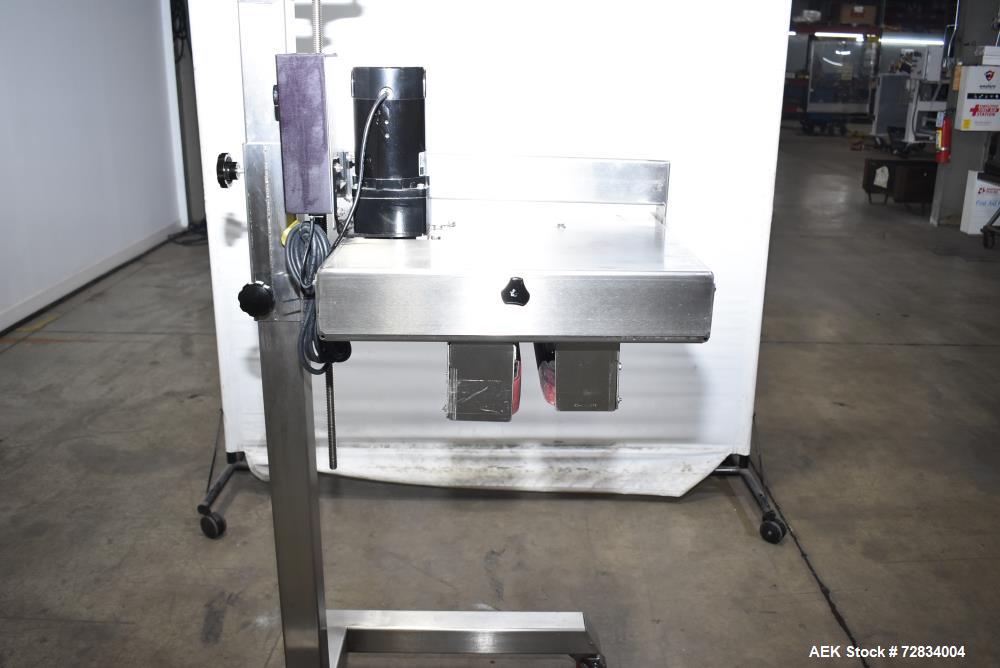Used Garvey Side Belt Gap Transfer Conveyor. (2) Belts, approximate 39" long x 2" wide. Adjustable height. Mounted on casters. Last used with Video Jet coder for bottom date coding. 1/60/115 Volt.