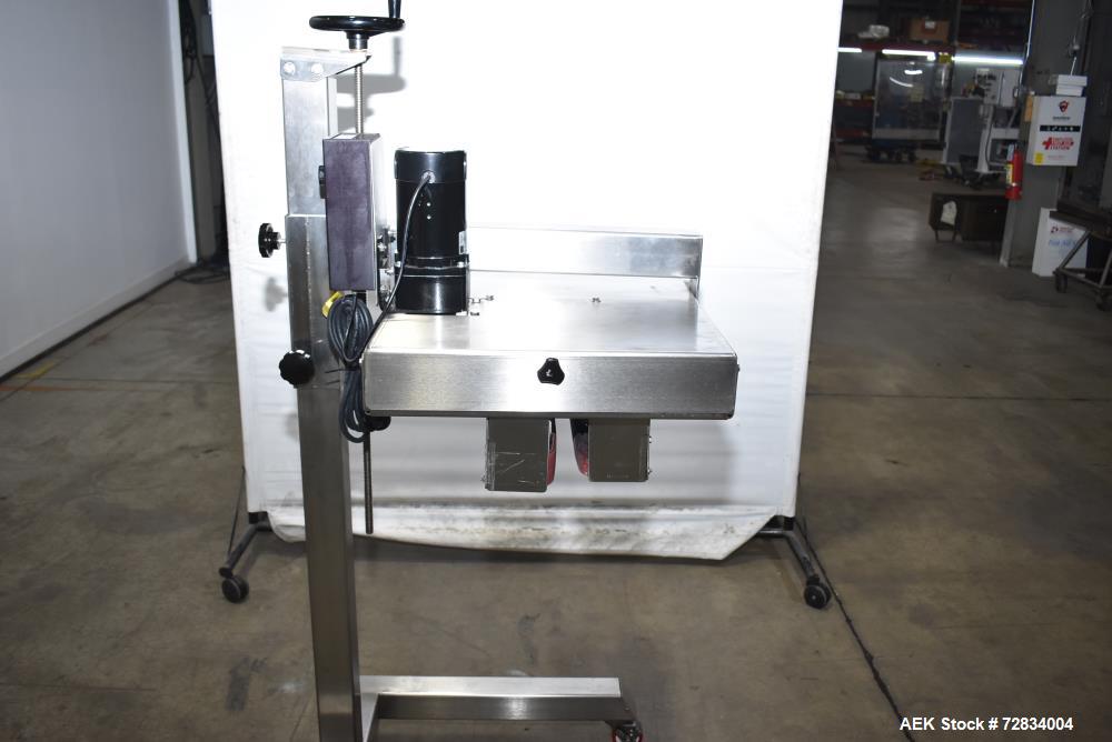 Used Garvey Side Belt Gap Transfer Conveyor. (2) Belts, approximate 39" long x 2" wide. Adjustable height. Mounted on casters. Last used with Video Jet coder for bottom date coding. 1/60/115 Volt.