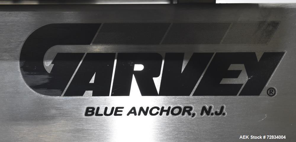 Used Garvey Side Belt Gap Transfer Conveyor. (2) Belts, approximate 39" long x 2" wide. Adjustable height. Mounted on casters. Last used with Video Jet coder for bottom date coding. 1/60/115 Volt.