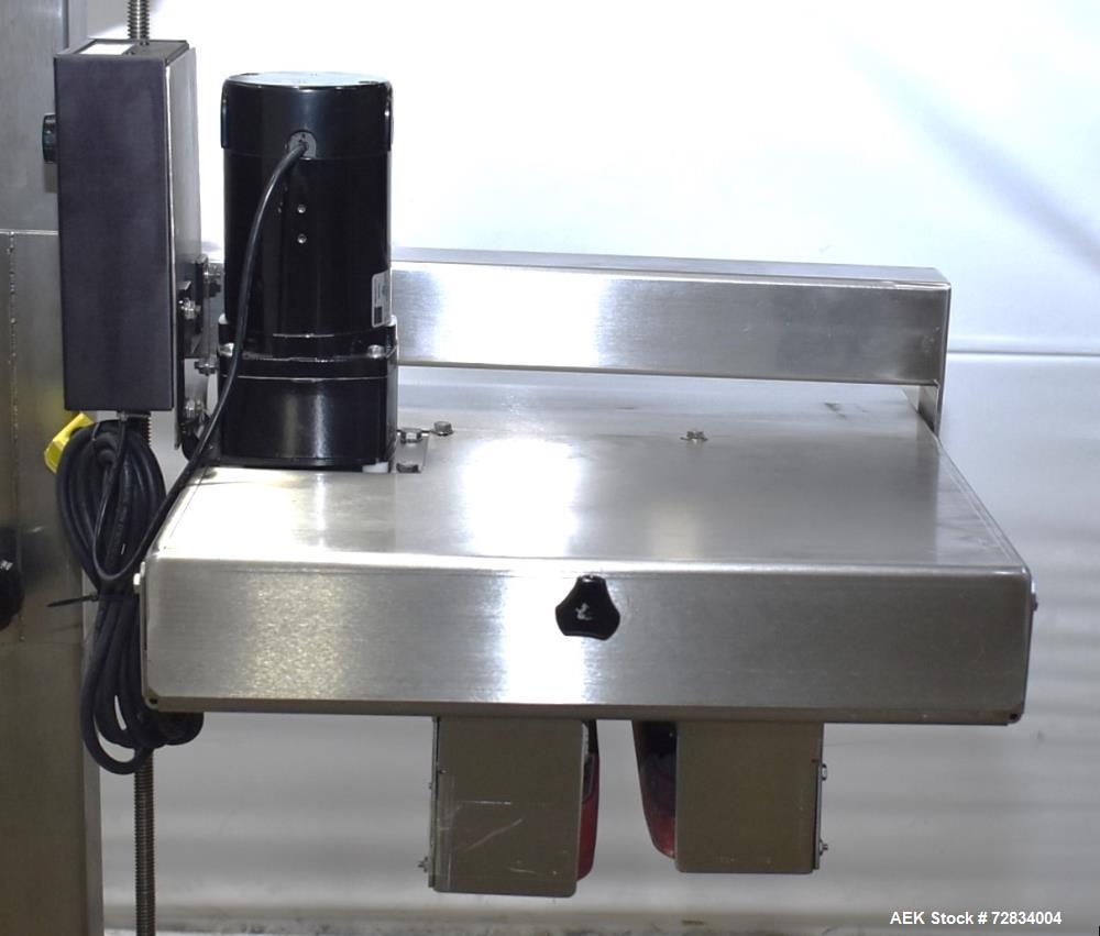 Used Garvey Side Belt Gap Transfer Conveyor. (2) Belts, approximate 39" long x 2" wide. Adjustable height. Mounted on casters. Last used with Video Jet coder for bottom date coding. 1/60/115 Volt.