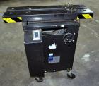 Used Dennison M400 Side Belt Gap Transfer Conveyor. Capable of speeds up to 250 CPM.  Side belt transfer for bottom coding of containers. Container size range: (length) 1