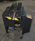Used Dennison M400 Side Belt Gap Transfer Conveyor. Capable of speeds up to 250 CPM.  Side belt transfer for bottom coding of containers. Container size range: (length) 1