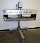 Used Side Belt Portable Transfer Conveyor. (2) Approximate 1” wide x 45” long side belts, manually adjustable to a maximum opening to 5-1/4”. Driven by a 1hp, 3/60/208-230/460 volt, 1750 rpm gear mot...