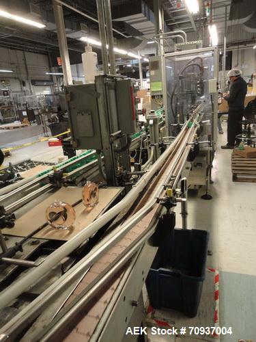 Used “Puck Conveyor System” with stainless steel bed 3 1/4” table top chain conveyor, dual side rails, configured in a racetrack design to supply pucks for packaging and return empty pucks to supply.