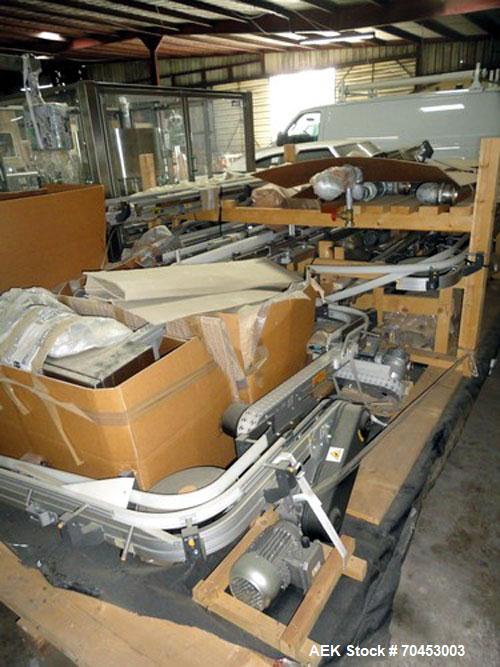 Used Flexible link style Conveyor System, not installed, 2-1/2" wide x approximately 100' long including straight and radius sections, with multiple drives and a control panel on skid.