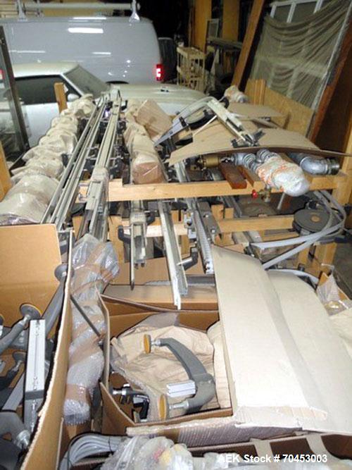 Used Flexible link style Conveyor System, not installed, 2-1/2" wide x approximately 100' long including straight and radius sections, with multiple drives and a control panel on skid.