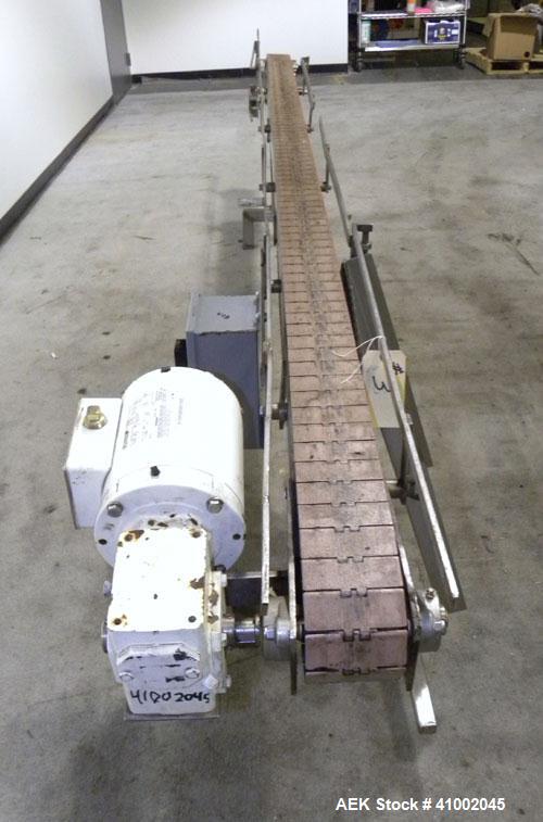 Used Plastic Belt Conveyor. 4" wide x 124" long belt. Driven by a 1/2 hp, 3/60/208-230/460 volt, 1725 rpm gearmotor, ratio 15 to 1. Mounted on a stainless steel frame and legs.