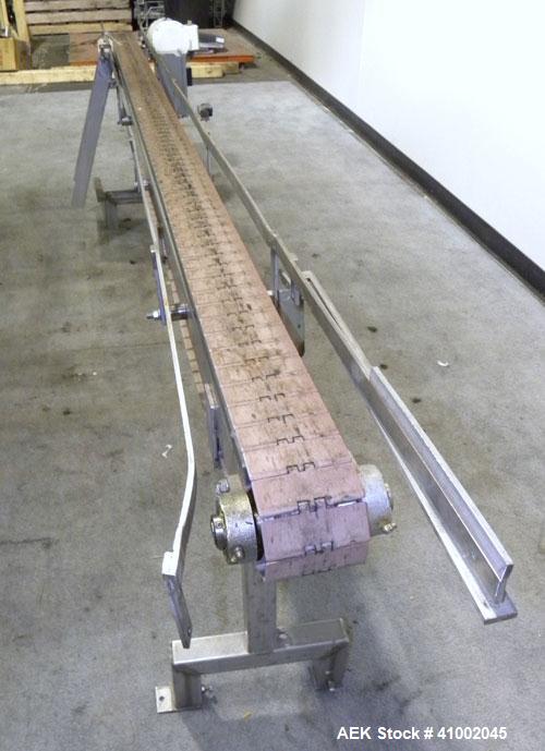 Used Plastic Belt Conveyor. 4" wide x 124" long belt. Driven by a 1/2 hp, 3/60/208-230/460 volt, 1725 rpm gearmotor, ratio 15 to 1. Mounted on a stainless steel frame and legs.