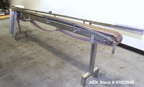 Used Plastic Belt Conveyor. 4" wide x 124" long belt. Driven by a 1/2 hp, 3/60/208-230/460 volt, 1725 rpm gearmotor, ratio 15 to 1. Mounted on a stainless steel frame and legs.