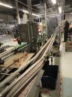 Used “Puck Conveyor System” with stainless steel bed 3 1/4” table top chain conveyor, dual side rails, configured in a racetrack design to supply pucks for packaging and return empty pucks to supply.