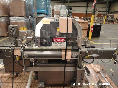 Used Lakso Model 71 Automatic Twin Head Cottoner capable of speeds up to 200 bottles per minute. Has 28" x 3-1/4" screw infeed. Can use natural or synthetic cotton up to 26 grams in inverted "U" conf...