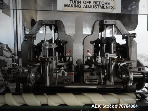 Used Lakso Model 71 Automatic Twin Head Cottoner capable of speeds up to 200 bottles per minute. Has 28" x 3-1/4" screw infeed. Can use natural or synthetic cotton up to 26 grams in inverted "U" conf...