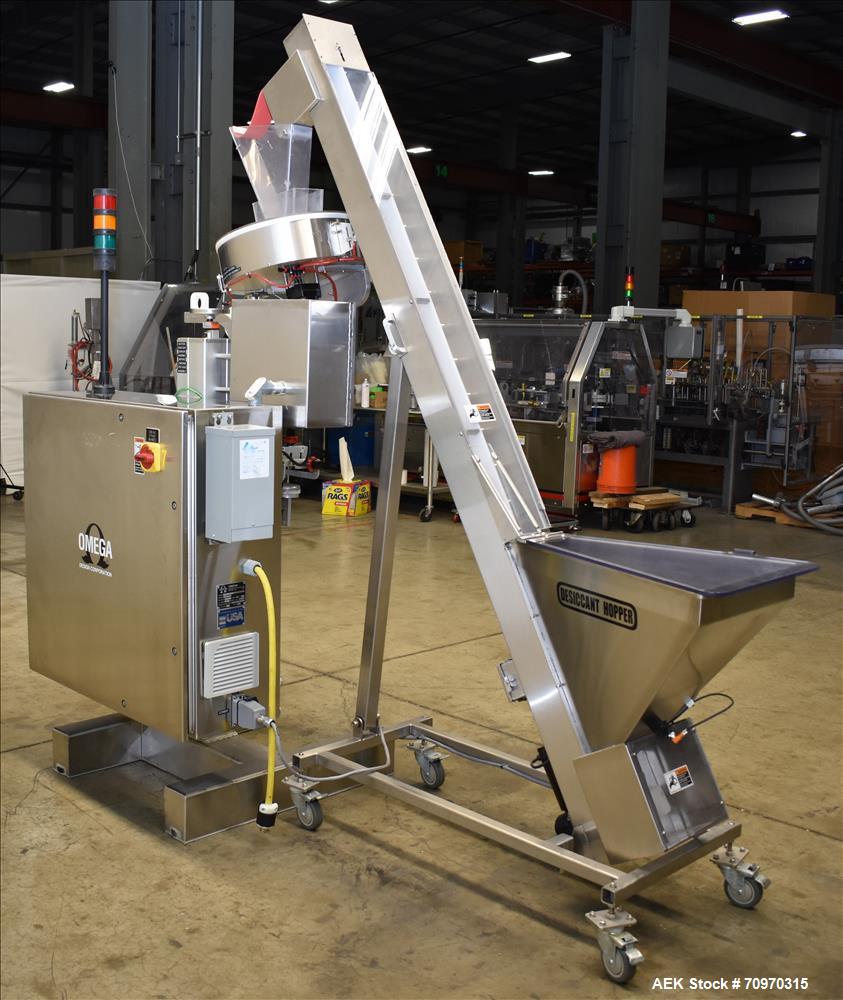 Used Omega Design Omni Feeder Combination Canister Desiccant Feeder. Capable of speeds up to 600 CPM (Single Drop) or 300 CPM (Double Drop). Servo operation, Allen Bradley PLC with integrated touch s...