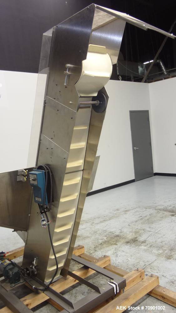 Used Incline Cleated Belt Conveyor, 304 Stainless Steel. 10-3/4" Wide X 75" long belt, with 2" tall cleats spaced approximate 6" apart. Hopper is 51" long x 44" wide x 34" deep. Unit driven by a 1/4 ...