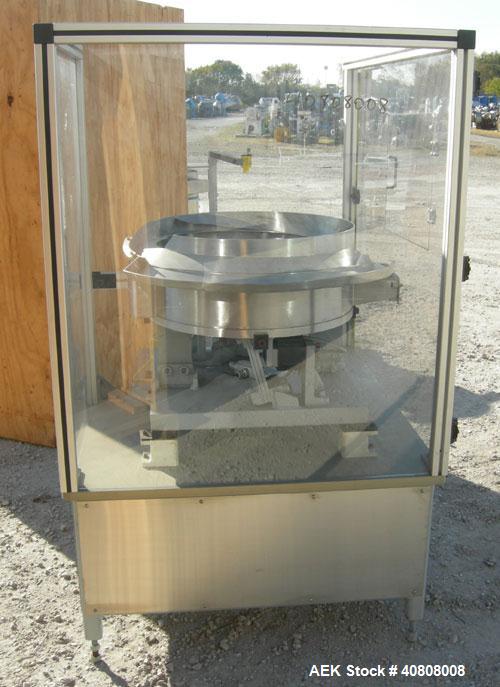 Used Vibratory Parts Feeder, 304 stainless steel. 20'' diameter x 9'' deep feed pan. Mounted on a 23'' tall table.